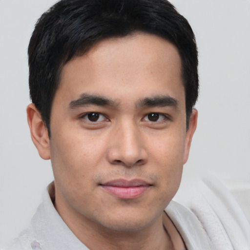 Joyful asian young-adult male with short  brown hair and brown eyes