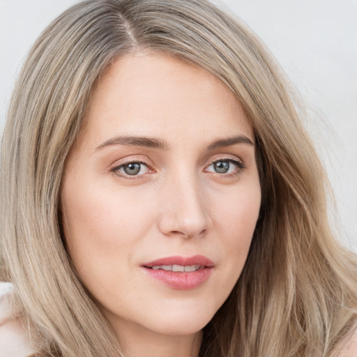 Joyful white young-adult female with long  brown hair and blue eyes