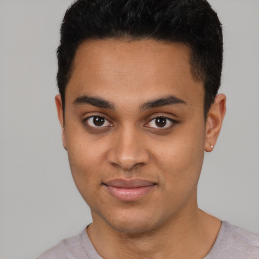 Joyful latino young-adult male with short  black hair and brown eyes