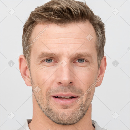 Joyful white adult male with short  brown hair and grey eyes