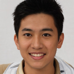 Joyful asian young-adult male with short  brown hair and brown eyes