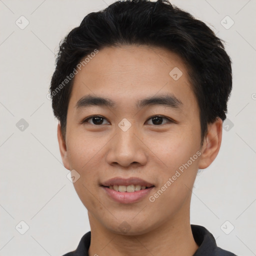 Joyful asian young-adult male with short  black hair and brown eyes