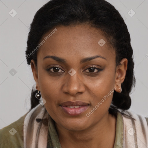 Joyful black adult female with long  brown hair and brown eyes