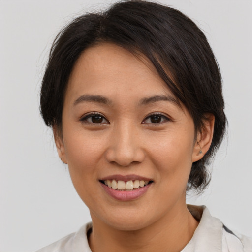 Joyful asian young-adult female with medium  brown hair and brown eyes