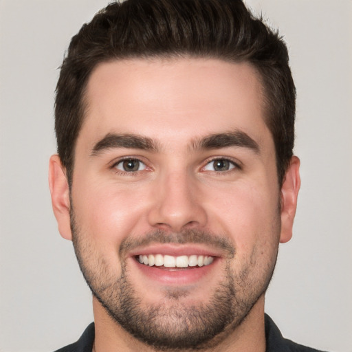 Joyful white young-adult male with short  brown hair and brown eyes