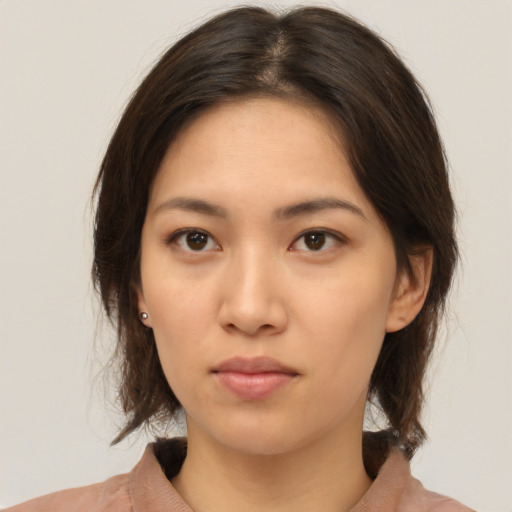 Neutral asian young-adult female with medium  brown hair and brown eyes