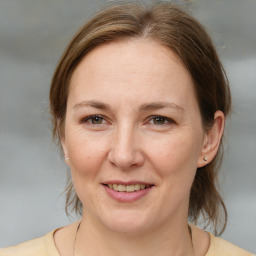 Joyful white adult female with medium  brown hair and brown eyes