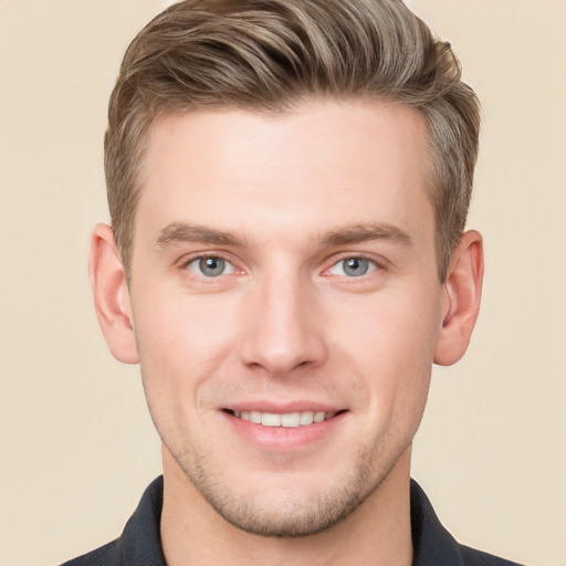 Joyful white young-adult male with short  brown hair and grey eyes