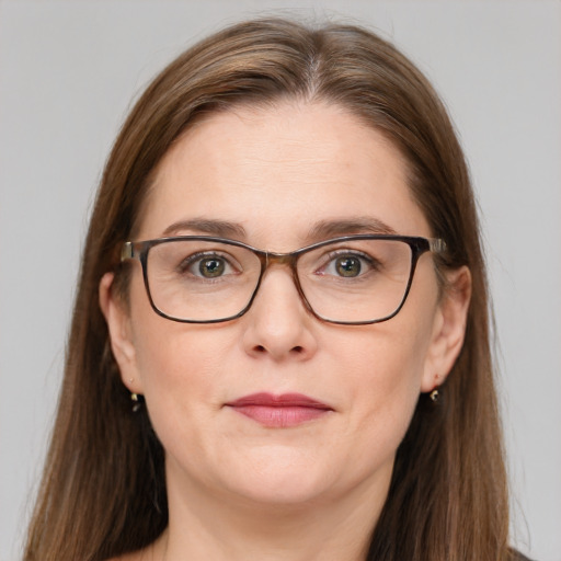 Joyful white adult female with long  brown hair and grey eyes