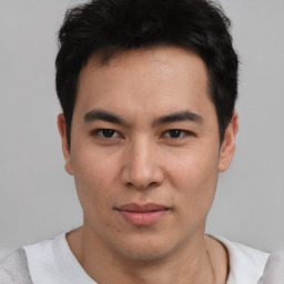 Joyful asian young-adult male with short  black hair and brown eyes