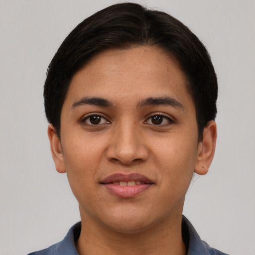 Joyful latino young-adult female with short  black hair and brown eyes