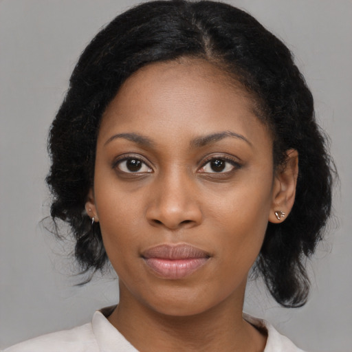 Joyful black young-adult female with medium  black hair and brown eyes