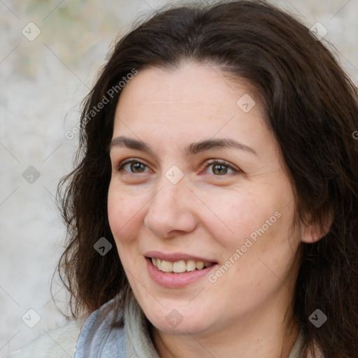 Joyful white adult female with long  brown hair and brown eyes