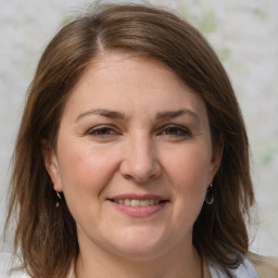 Joyful white adult female with medium  brown hair and brown eyes