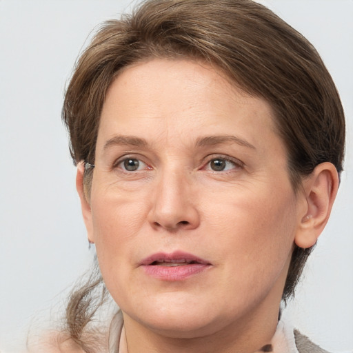 Joyful white adult female with medium  brown hair and grey eyes