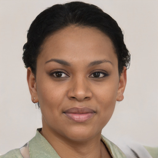 Joyful black young-adult female with short  black hair and brown eyes