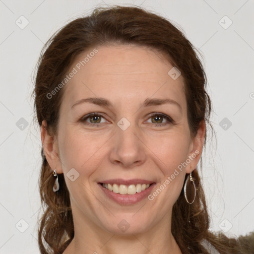 Joyful white adult female with long  brown hair and grey eyes