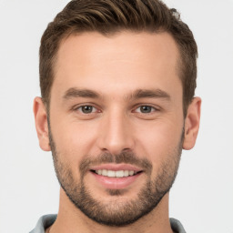 Joyful white young-adult male with short  brown hair and brown eyes