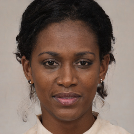 Joyful black young-adult female with medium  black hair and brown eyes