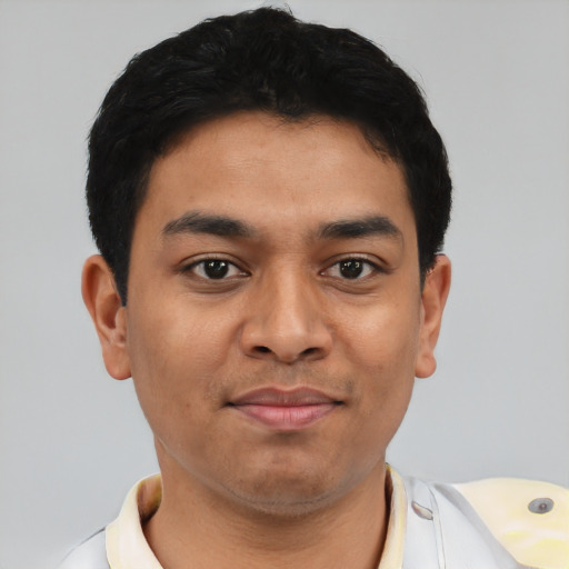 Joyful latino young-adult male with short  black hair and brown eyes