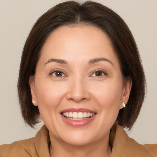 Joyful white adult female with medium  brown hair and brown eyes