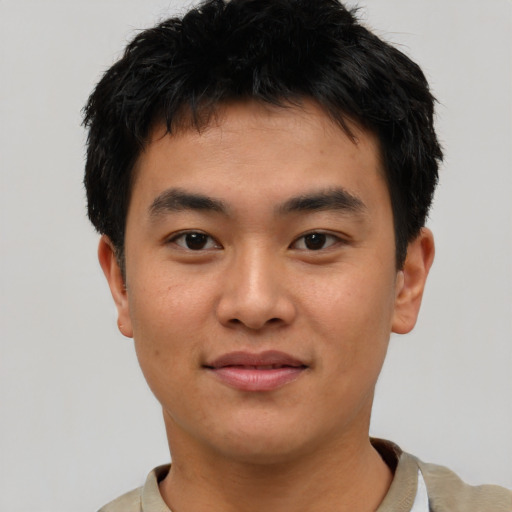 Joyful asian young-adult male with short  black hair and brown eyes