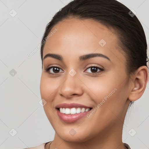 Joyful white young-adult female with long  brown hair and brown eyes