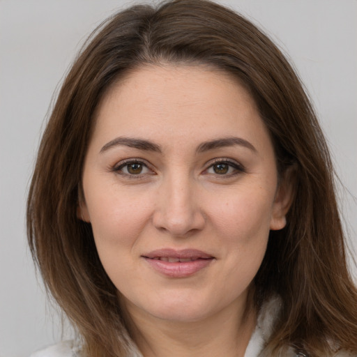 Joyful white young-adult female with medium  brown hair and brown eyes