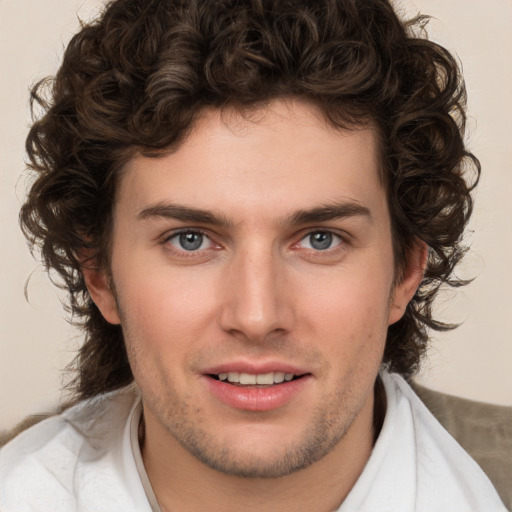 Joyful white young-adult male with medium  brown hair and brown eyes