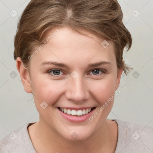 Joyful white young-adult female with short  brown hair and grey eyes