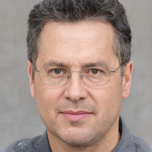 Joyful white middle-aged male with short  brown hair and brown eyes