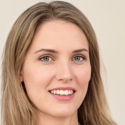 Joyful white young-adult female with long  brown hair and green eyes