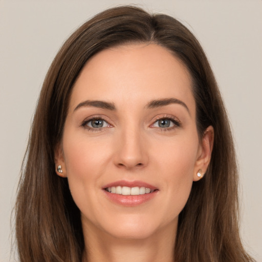 Joyful white young-adult female with long  brown hair and brown eyes