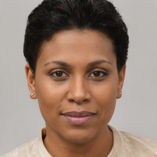 Joyful black young-adult female with short  brown hair and brown eyes