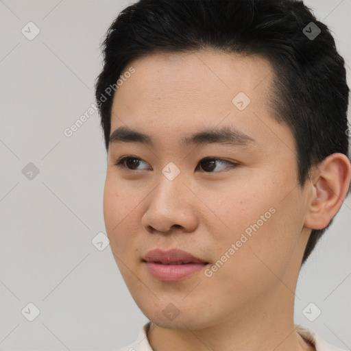 Joyful asian young-adult male with short  brown hair and brown eyes