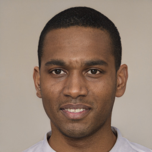 Joyful black young-adult male with short  black hair and brown eyes