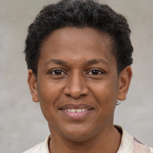 Joyful latino adult male with short  brown hair and brown eyes