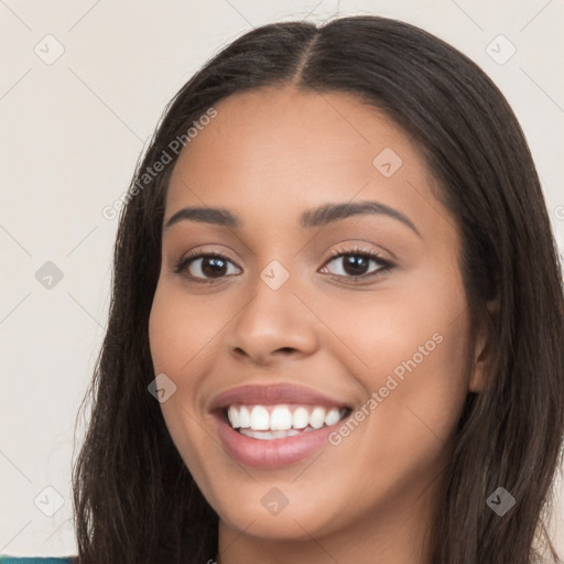 Joyful white young-adult female with long  brown hair and brown eyes