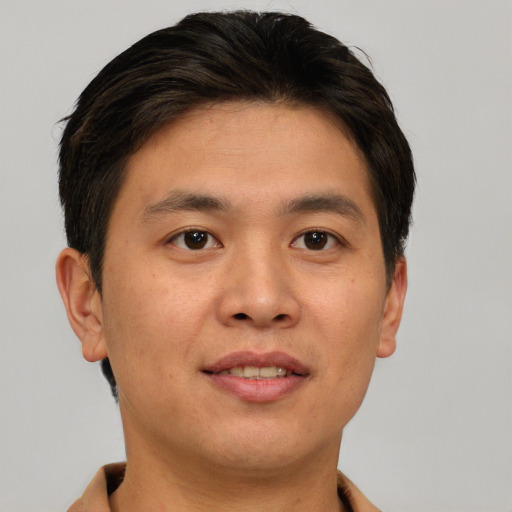 Joyful asian young-adult male with short  brown hair and brown eyes