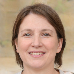 Joyful white adult female with medium  brown hair and brown eyes