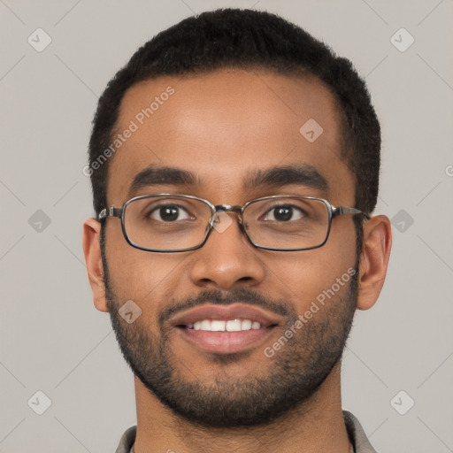 Joyful black young-adult male with short  brown hair and brown eyes