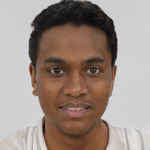 Joyful black young-adult male with short  black hair and brown eyes