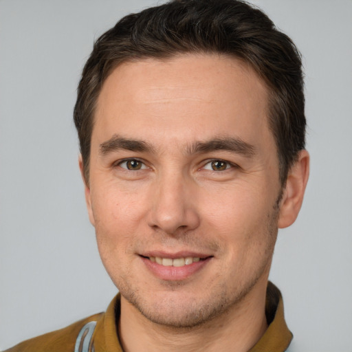 Joyful white adult male with short  brown hair and brown eyes