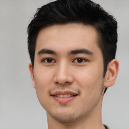 Joyful asian young-adult male with short  brown hair and brown eyes