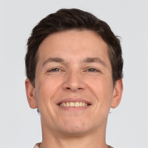 Joyful white adult male with short  brown hair and brown eyes