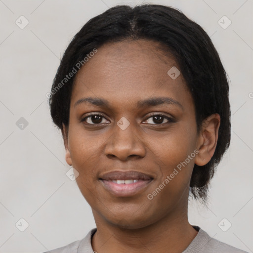 Joyful black young-adult female with short  black hair and brown eyes