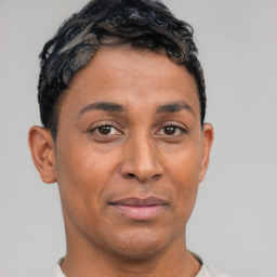 Joyful latino young-adult male with short  brown hair and brown eyes