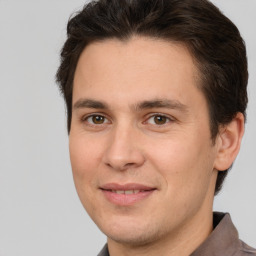 Joyful white adult male with short  brown hair and brown eyes