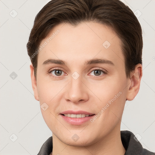 Joyful white young-adult female with short  brown hair and grey eyes