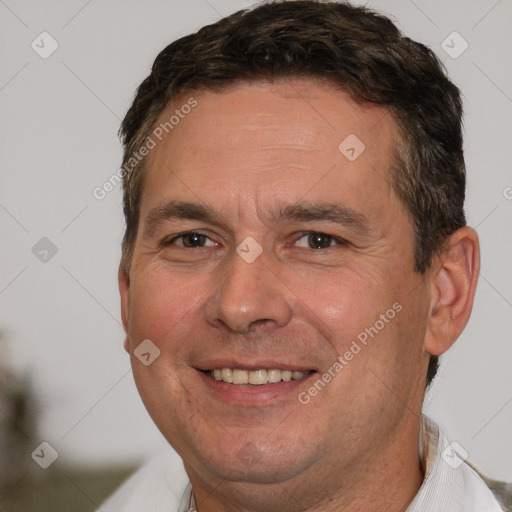 Joyful white adult male with short  brown hair and brown eyes